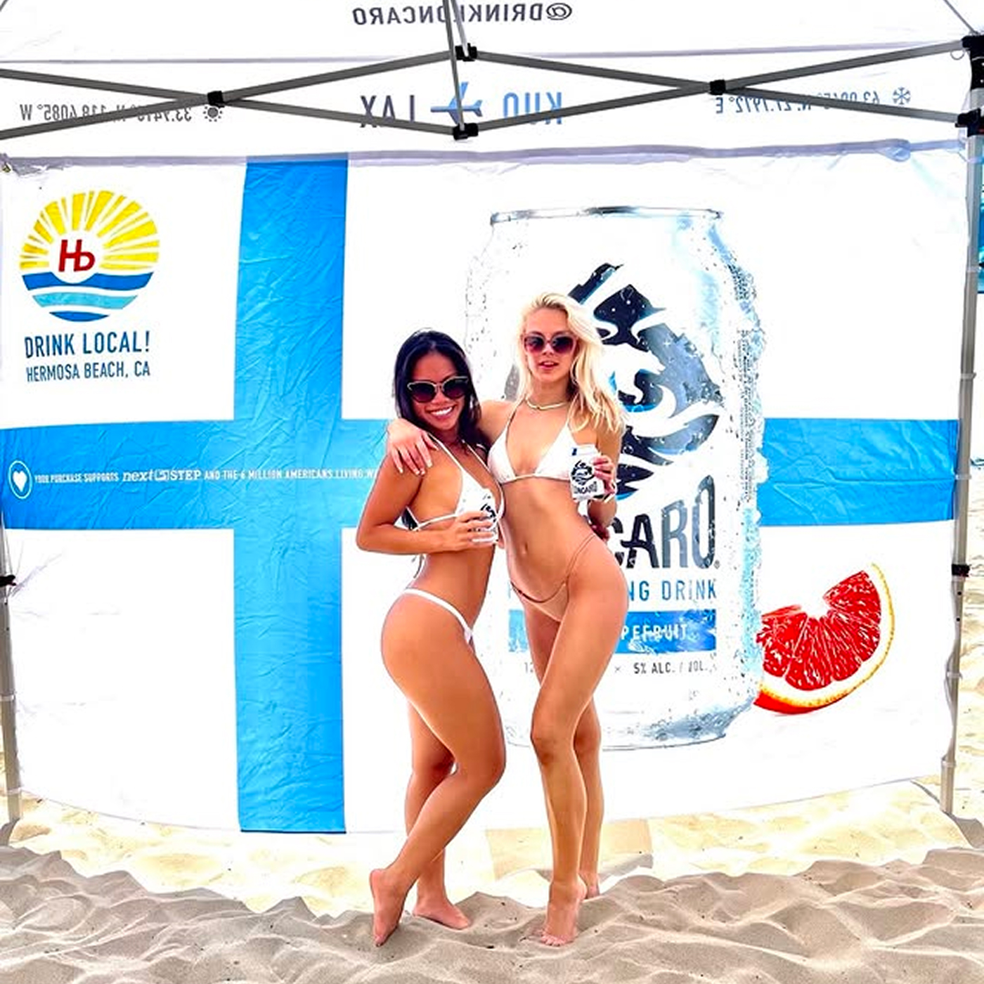 Two girls posing with can